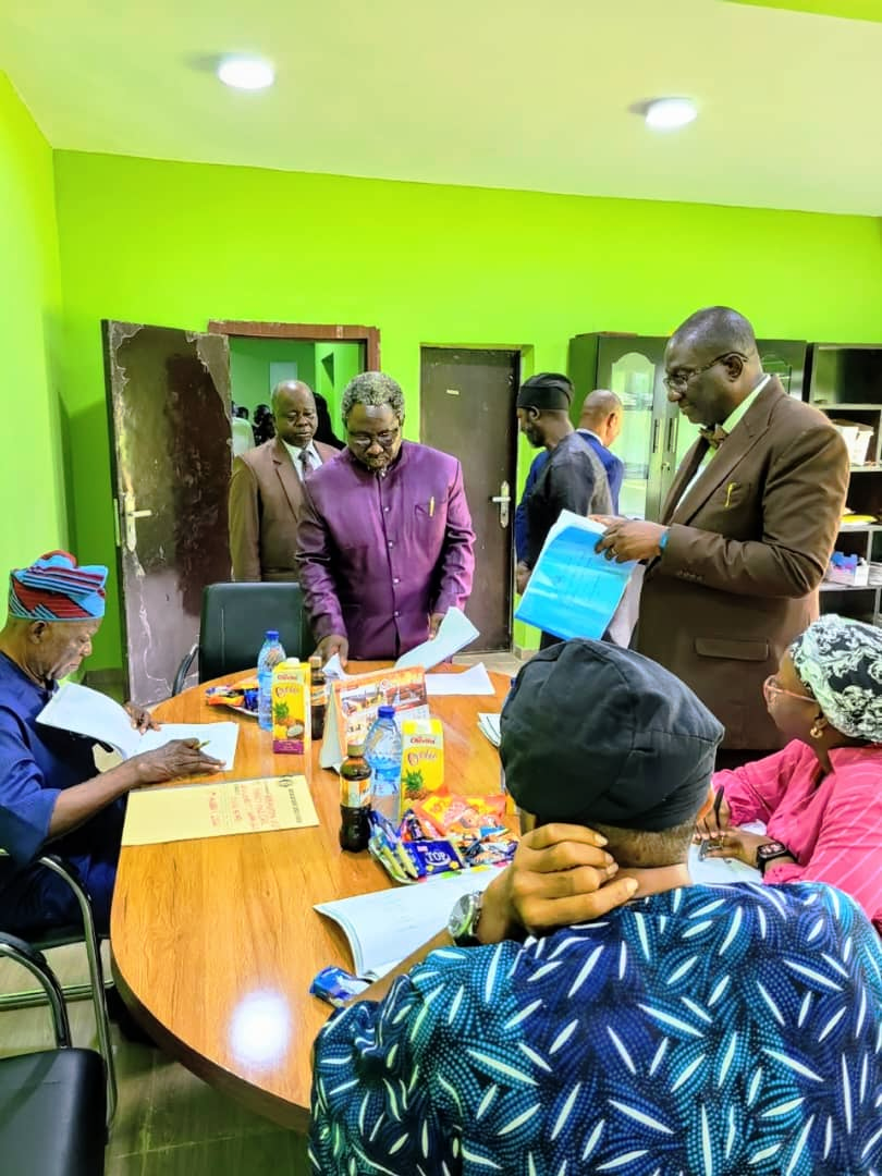 Delegation and University officials reviewing accreditation documents